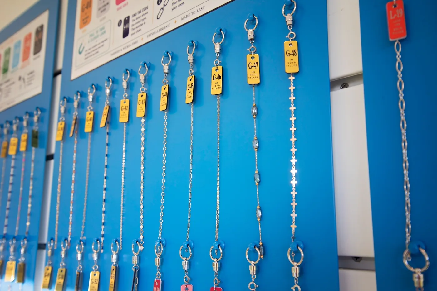 Numbered 14k gold-filled chain options hanging along the I Shine display wall at Margaritaville Beach Resort Fort Myers Beach