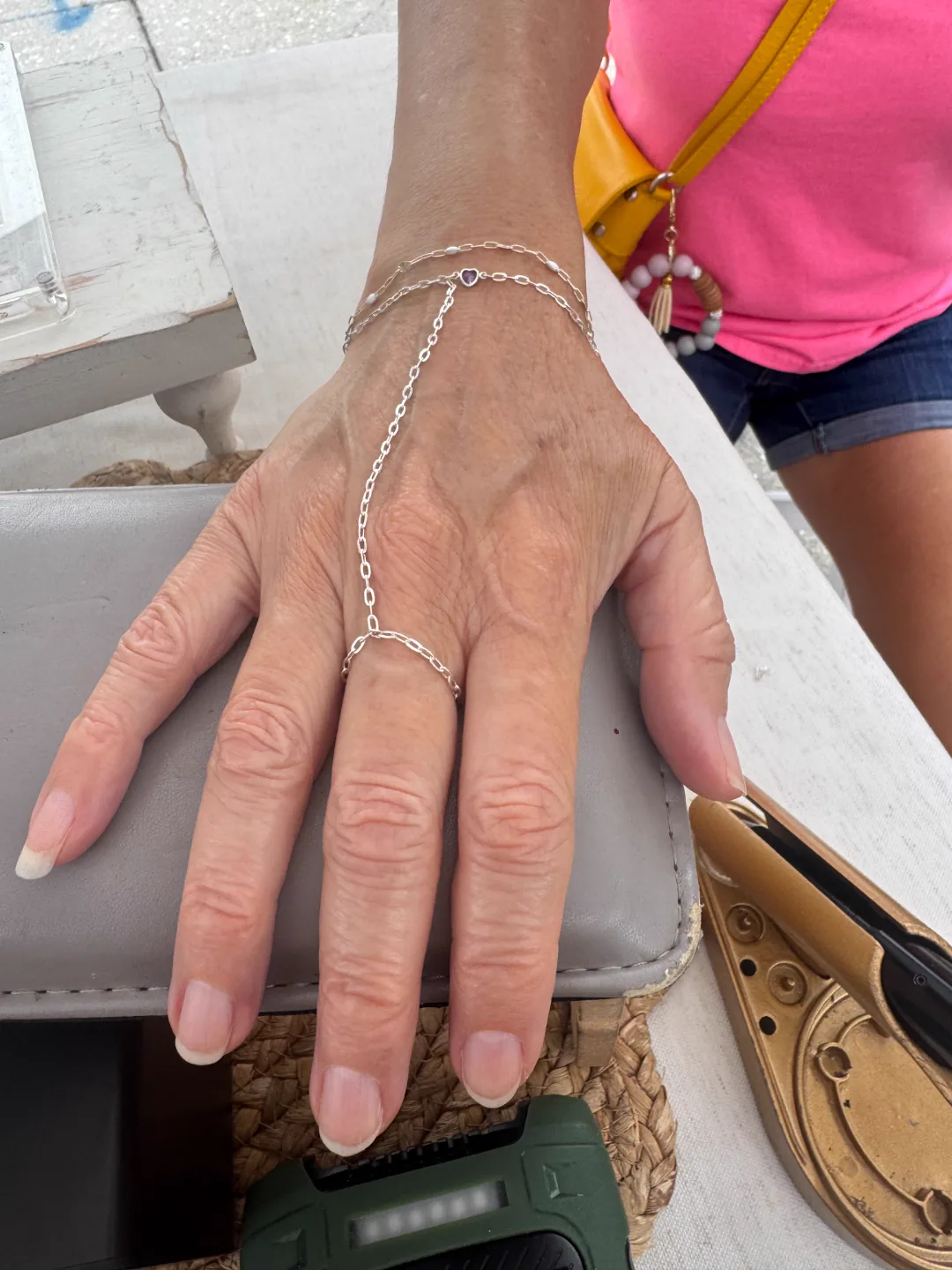 Delicate silver double-strand hand-chain wrapped from bracelet to finger